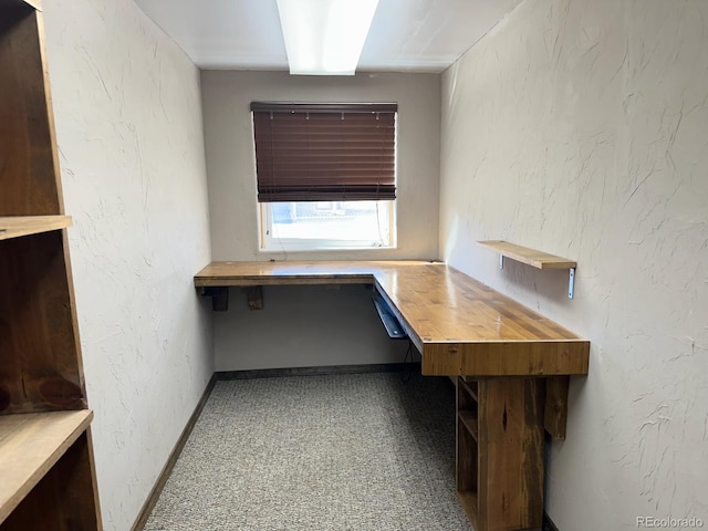 unfurnished office featuring built in desk