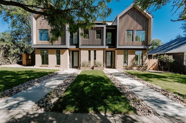 2530 Chase, Edgewater, CO 80215 - view of front facade with a front yard, brick siding, and board and batten siding