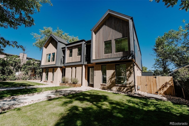 2530 Chase, Edgewater, CO 80215 - rear view of house featuring brick siding and board and batten siding