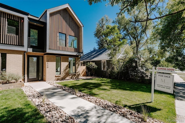 2530 Chase, Edgewater, CO 80215 - view of front of home with brick siding, a front lawn, and board and batten siding