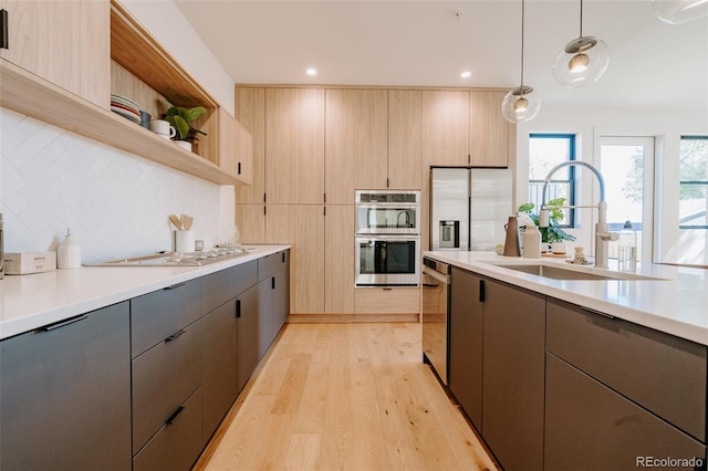 2530 Chase, Edgewater, CO 80215 - kitchen featuring stainless steel appliances, a sink, light countertops, open shelves, and light wood-type flooring