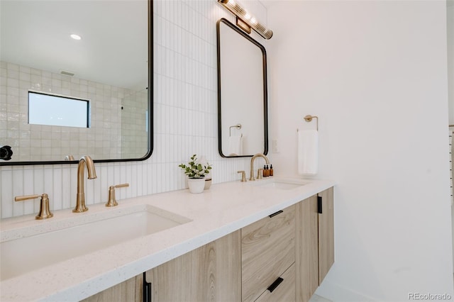 2530 Chase, Edgewater, CO 80215 - bathroom featuring double vanity, tasteful backsplash, and tiled shower