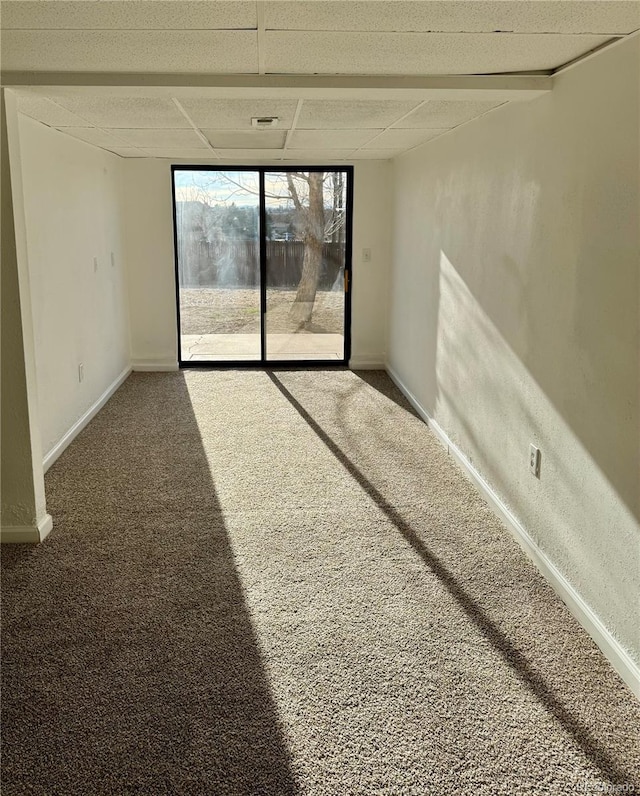 unfurnished room featuring carpet flooring and a paneled ceiling