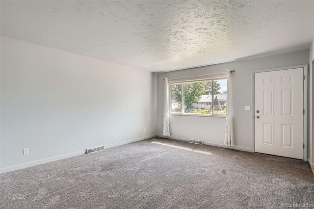 1785 S Zuni St, Denver, CO 80223 - carpeted empty room with baseboards and a textured ceiling
