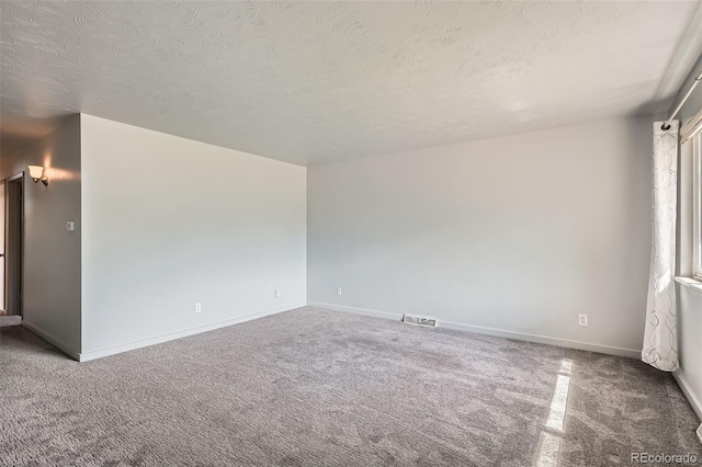 1785 S Zuni St, Denver, CO 80223 - carpeted empty room with a textured ceiling and baseboards