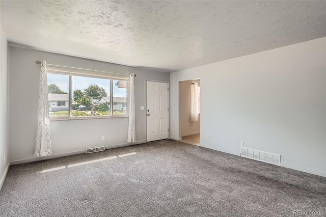1785 S Zuni St, Denver, CO 80223 - carpeted empty room featuring baseboards and a textured ceiling