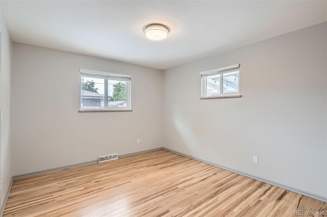 1785 S Zuni St, Denver, CO 80223 - empty room with plenty of natural light and wood finished floors