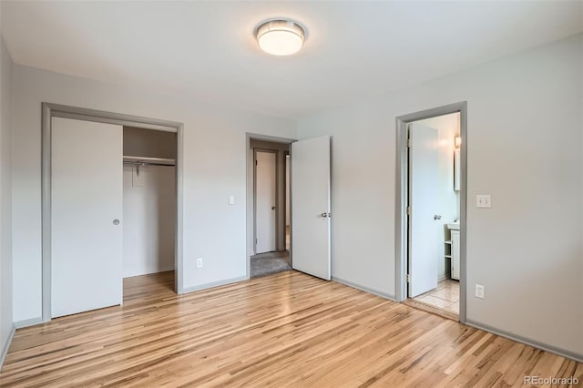 1785 S Zuni St, Denver, CO 80223 - unfurnished bedroom featuring light wood-style flooring, a closet, and ensuite bath