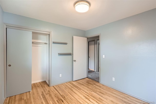 1785 S Zuni St, Denver, CO 80223 - unfurnished bedroom with light wood-style flooring and a closet