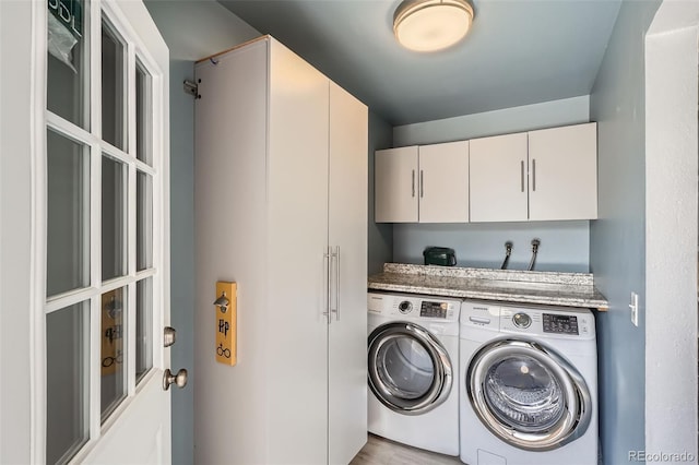 1785 S Zuni St, Denver, CO 80223 - laundry area featuring cabinet space, washer and clothes dryer, and light wood finished floors