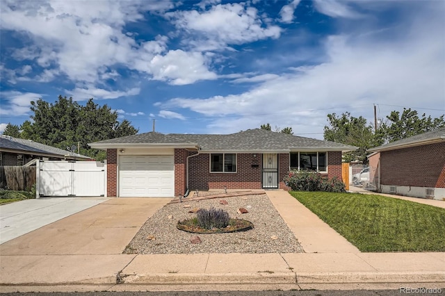 1785 S Zuni St, Denver, CO 80223 - ranch-style home featuring brick siding, an attached garage, driveway, a gate, and a shingled roof