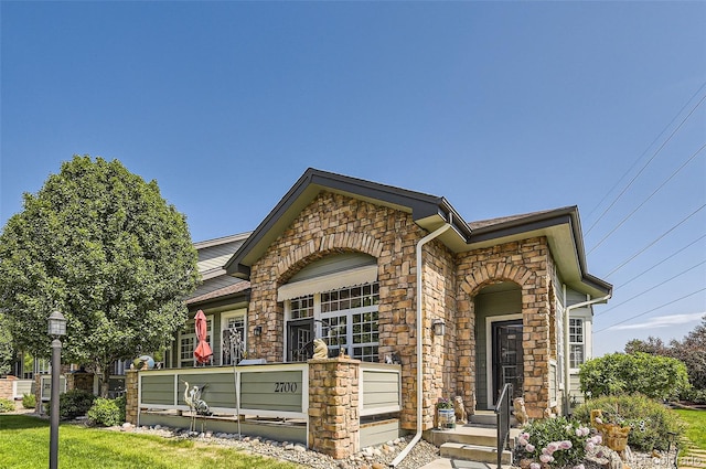 2700 W Greens Pl, Littleton, CO 80123 - view of front of house featuring stone siding and a front lawn