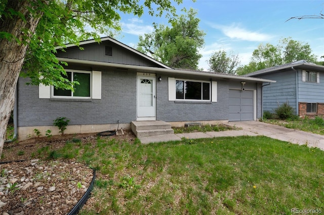 838 Kingsley Dr, Colorado Springs, CO 80909 - view of front facade with an attached garage, brick siding, concrete driveway, a front lawn, and board and batten siding