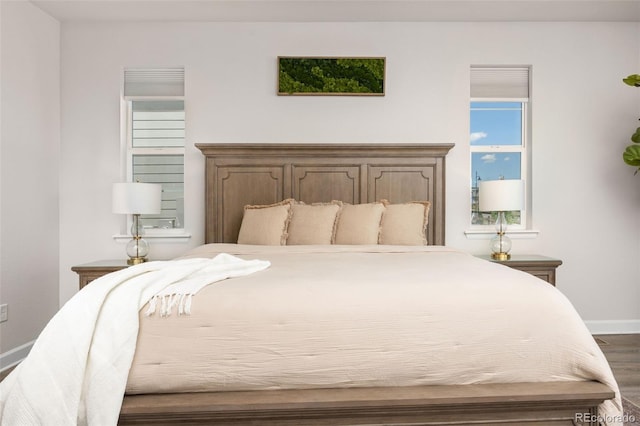 bedroom featuring dark wood-type flooring and baseboards