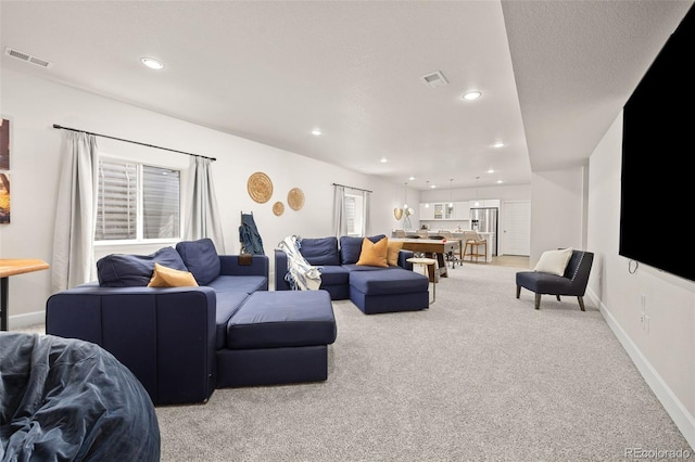 living area with light carpet, recessed lighting, and visible vents
