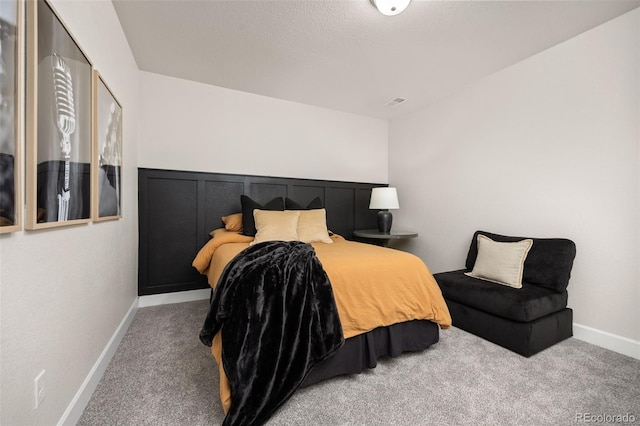 bedroom with carpet floors and baseboards
