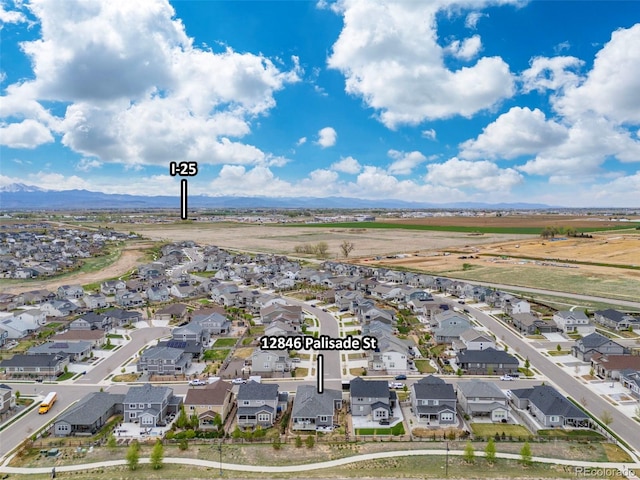 drone / aerial view featuring a residential view and a mountain view
