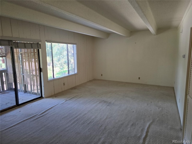 2525 S Dayton Way Unit 2307, Denver, CO 80231 - carpeted empty room with beamed ceiling and wooden walls