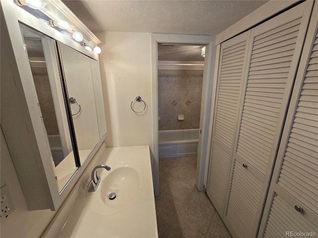 2525 S Dayton Way Unit 2307, Denver, CO 80231 - full bath with a closet, tile patterned flooring, a textured ceiling, vanity, and shower / bath combination