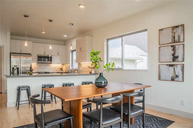 6892 Juniper Ct, Arvada, CO 80007 - dining area featuring light wood-style floors and recessed lighting