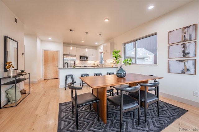 6892 Juniper Ct, Arvada, CO 80007 - dining space with light wood-style floors and recessed lighting