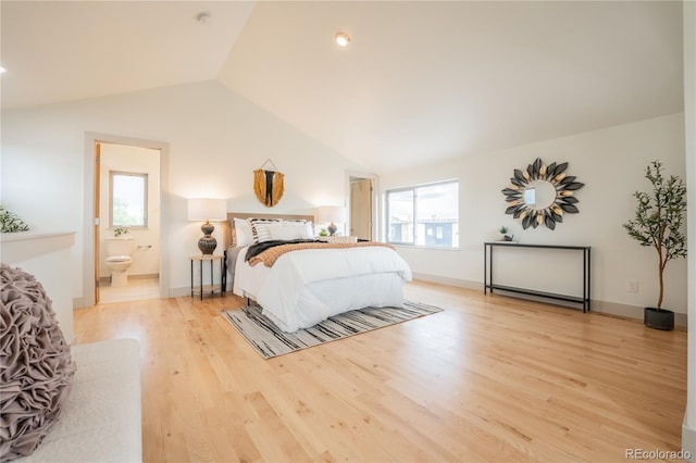 6892 Juniper Ct, Arvada, CO 80007 - bedroom featuring lofted ceiling, light wood-style floors, and ensuite bath