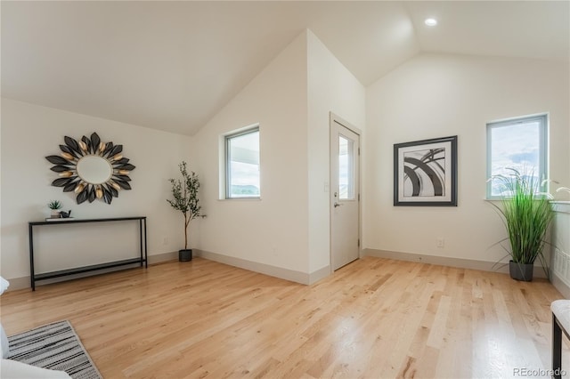 6892 Juniper Ct, Arvada, CO 80007 - foyer with light wood-style flooring and high vaulted ceiling