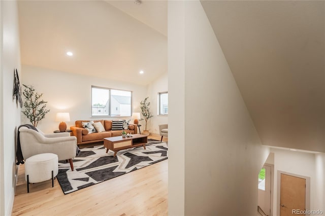 6892 Juniper Ct, Arvada, CO 80007 - living area featuring wood finished floors, lofted ceiling, and recessed lighting