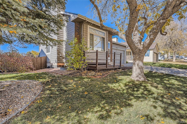 view of front of home with a garage and a front lawn