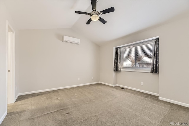 spare room featuring a wall unit AC, carpet floors, ceiling fan, and vaulted ceiling