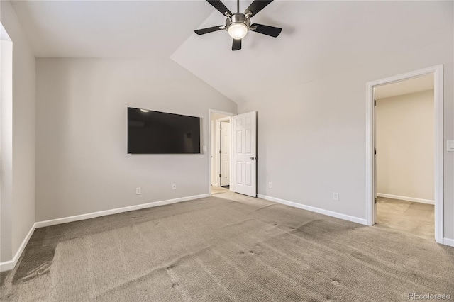 unfurnished bedroom featuring lofted ceiling, ceiling fan, a walk in closet, and light colored carpet