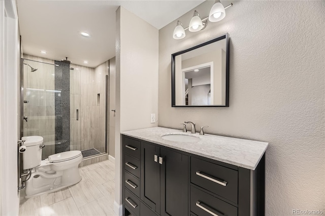 bathroom featuring toilet, vanity, and walk in shower