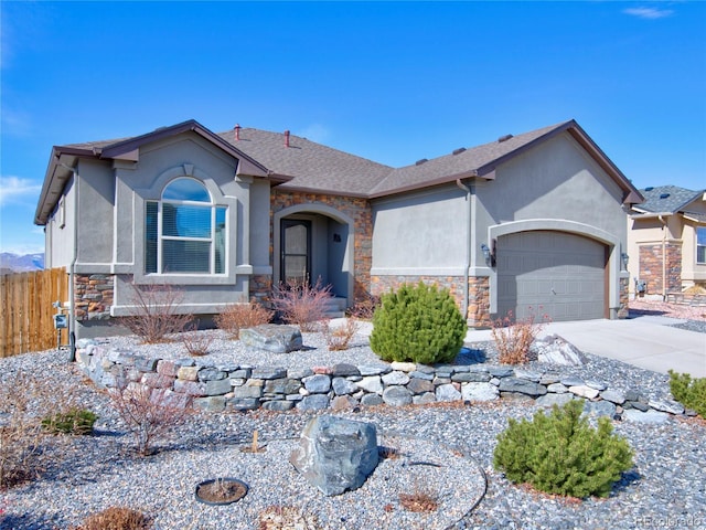 ranch-style house with stone siding, fence, driveway, and an attached garage