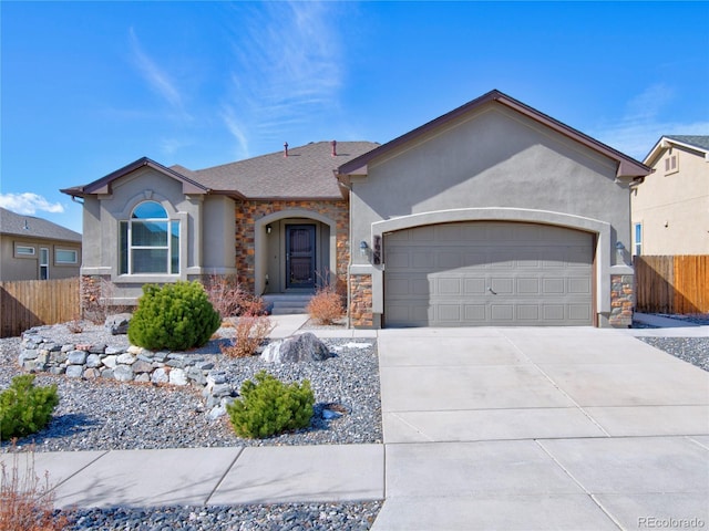 ranch-style house with a garage, fence, driveway, stone siding, and stucco siding