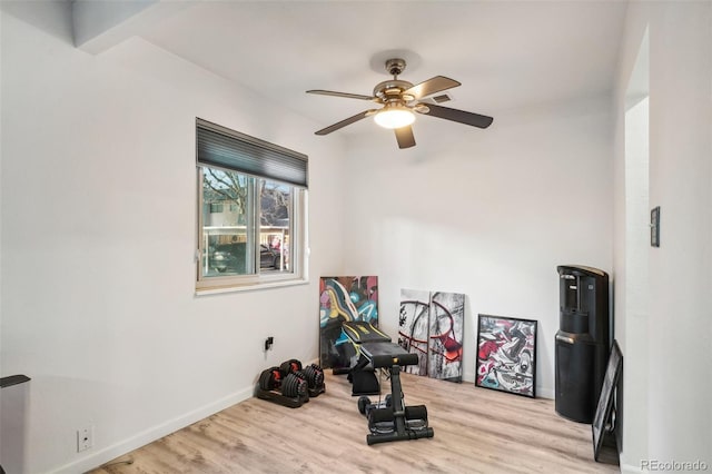 exercise area featuring ceiling fan and light hardwood / wood-style floors