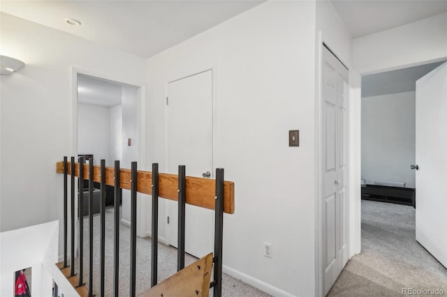 corridor featuring light colored carpet