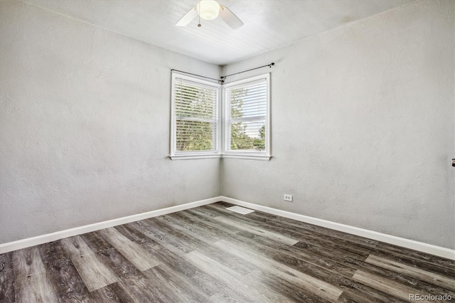 unfurnished room with ceiling fan and dark hardwood / wood-style floors