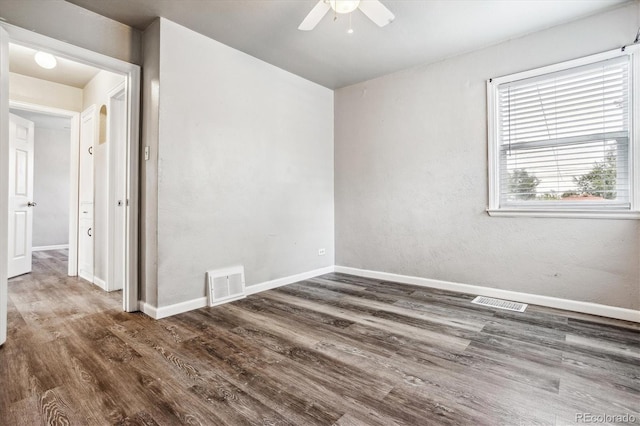 empty room featuring dark hardwood / wood-style floors and ceiling fan