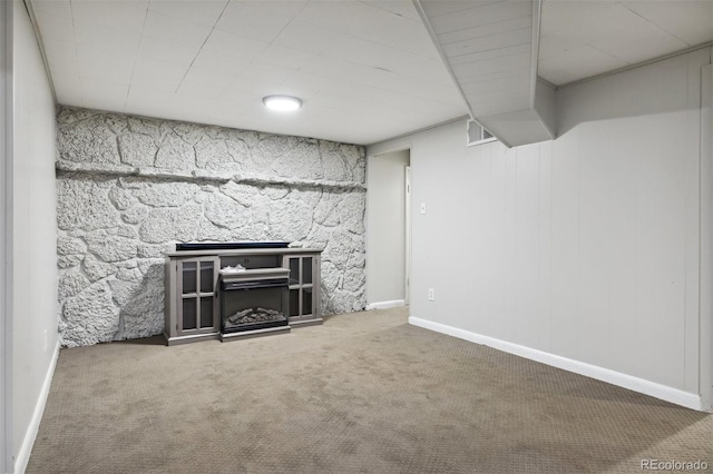 basement featuring carpet flooring and a fireplace