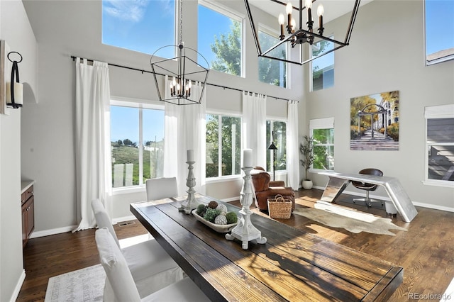 10601 Chadsworth Ln, Highlands Ranch, CO 80126 - dining room with a chandelier, a towering ceiling, and wood finished floors