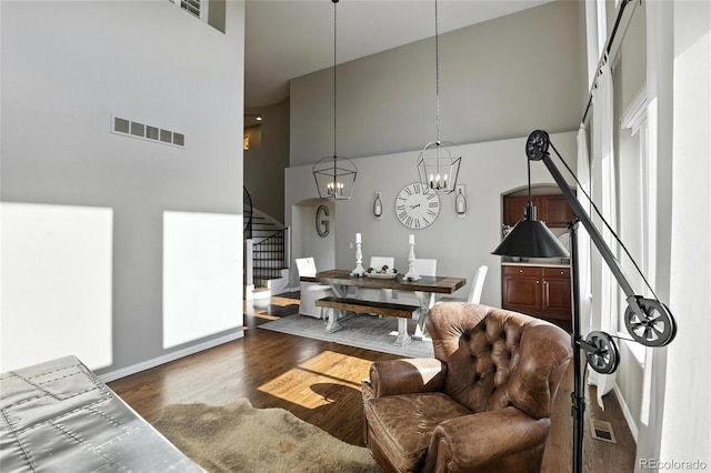 10601 Chadsworth Ln, Highlands Ranch, CO 80126 - living area featuring a high ceiling, stairs, wood finished floors, and a chandelier