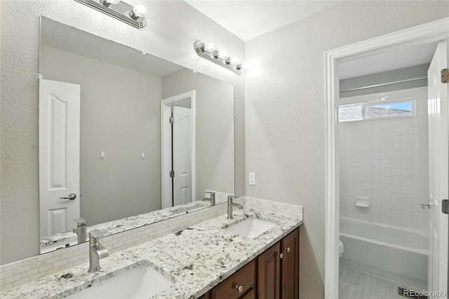 10601 Chadsworth Ln, Highlands Ranch, CO 80126 - bathroom featuring double vanity and shower / washtub combination