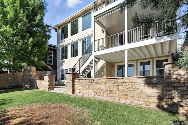 10601 Chadsworth Ln, Highlands Ranch, CO 80126 - back of house featuring stairs and a balcony