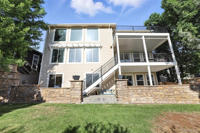 10601 Chadsworth Ln, Highlands Ranch, CO 80126 - back of house featuring stairs, a balcony, and a lawn