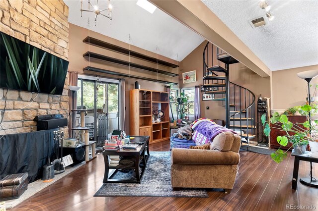 living room featuring high vaulted ceiling, wood-type flooring, and a textured ceiling