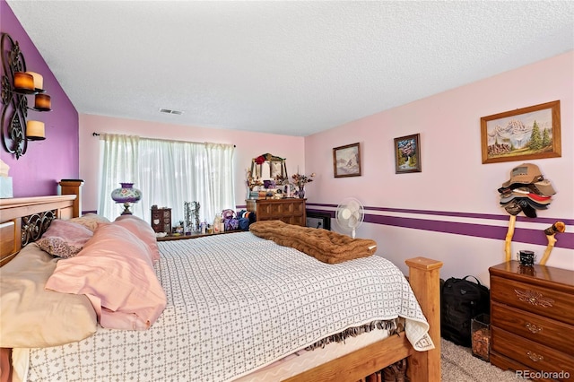 bedroom featuring a textured ceiling, carpet flooring, and visible vents