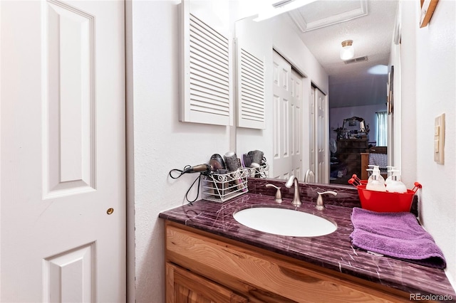 bathroom featuring vanity and a textured ceiling