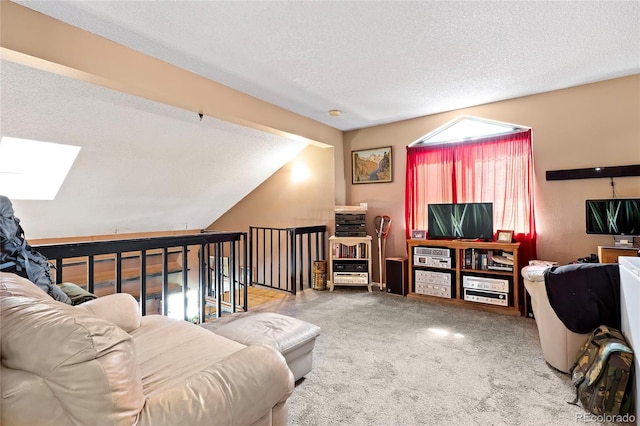 living room featuring a textured ceiling, light colored carpet, and vaulted ceiling with skylight