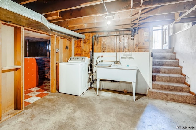 basement with a sink, washer / clothes dryer, and stairs