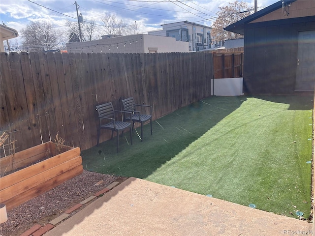 view of yard featuring a vegetable garden and fence